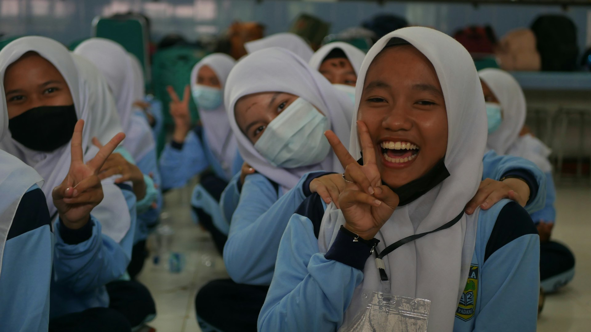 a group of young women wearing face masks